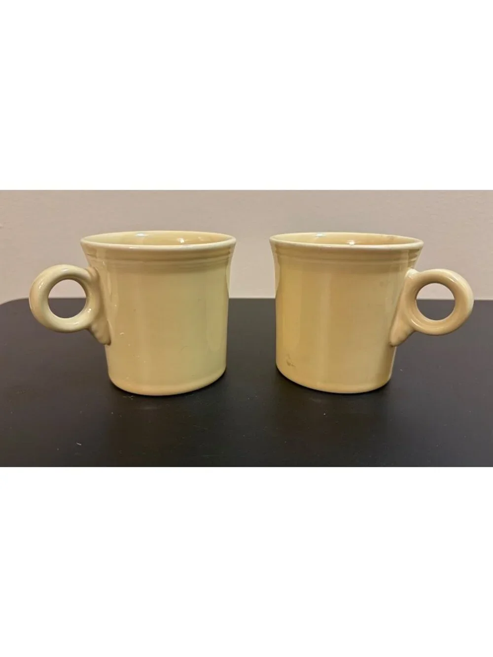 Pair of Fiesta Ware mugs in a light yellow glaze